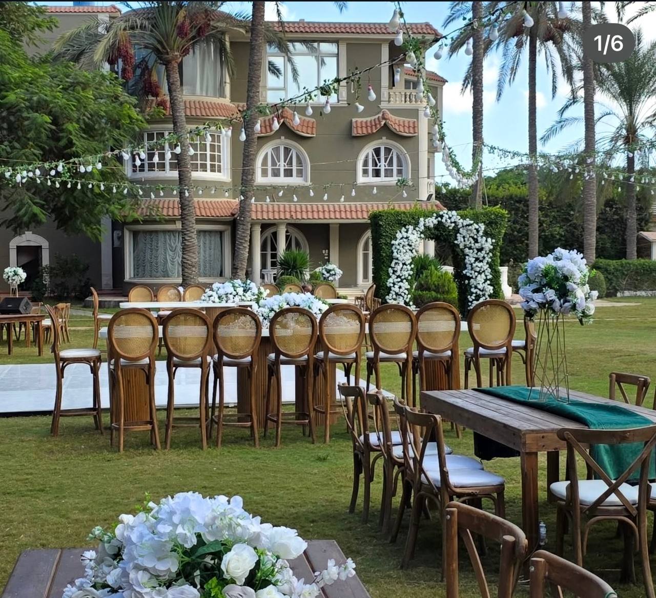The Kingdom Villa — garden wedding setup with palms and fairy lights